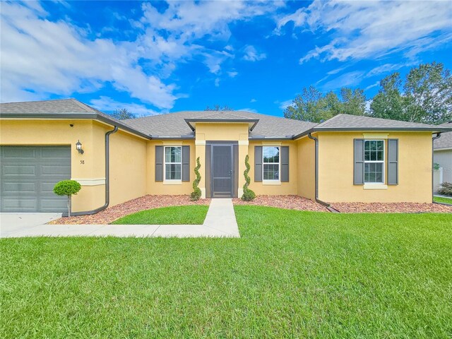 ranch-style home with a front lawn and a garage