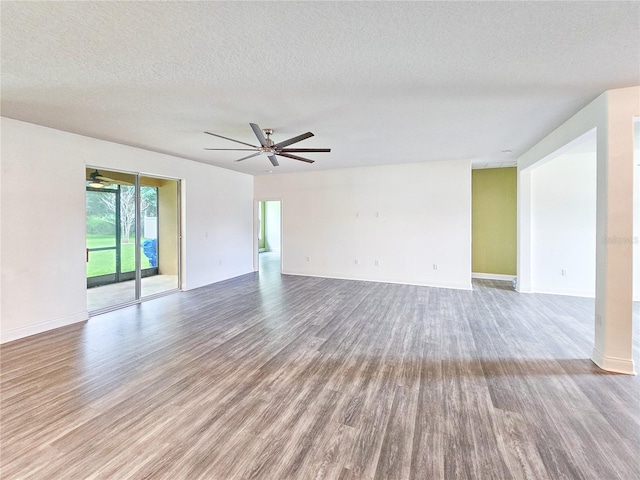 unfurnished room with ceiling fan, hardwood / wood-style flooring, and a textured ceiling