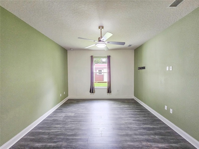 unfurnished room featuring ceiling fan, dark hardwood / wood-style floors, and a textured ceiling