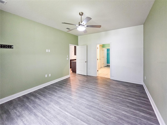 unfurnished bedroom with ceiling fan, a textured ceiling, ensuite bath, and hardwood / wood-style floors