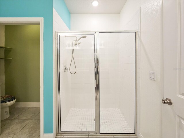 bathroom with walk in shower and toilet