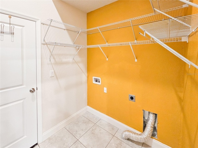 clothes washing area featuring tile patterned flooring, hookup for an electric dryer, and hookup for a washing machine