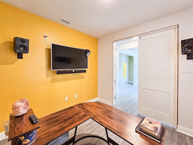 home office featuring a textured ceiling and hardwood / wood-style floors