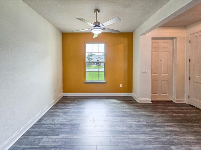 unfurnished room featuring ceiling fan, a textured ceiling, and dark hardwood / wood-style flooring