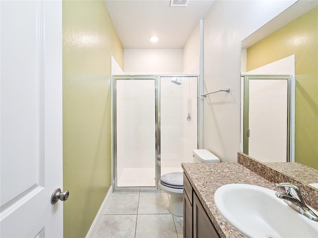 bathroom with vanity, a shower with shower door, toilet, and tile patterned flooring