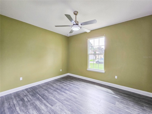 spare room featuring ceiling fan and dark hardwood / wood-style flooring