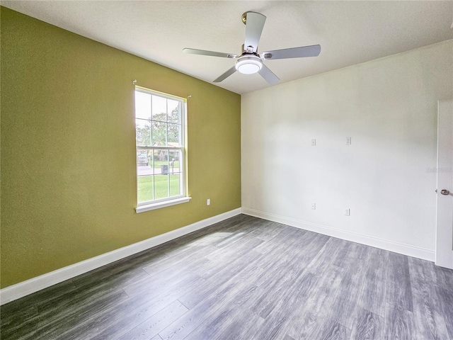 empty room featuring ceiling fan and dark hardwood / wood-style flooring