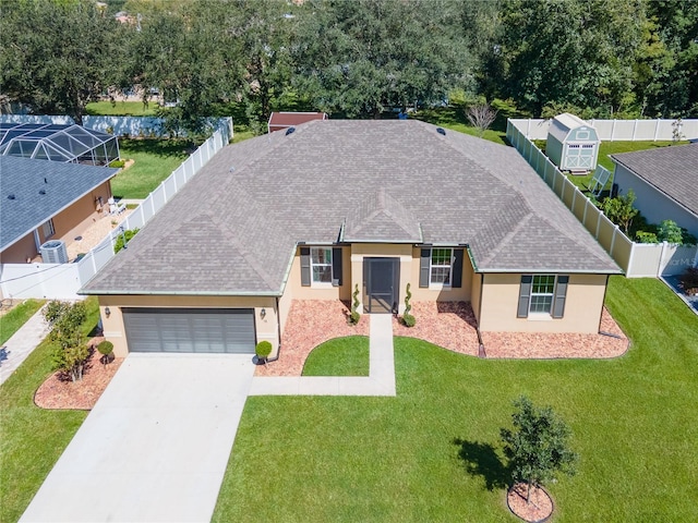 ranch-style home featuring a garage, cooling unit, and a front yard