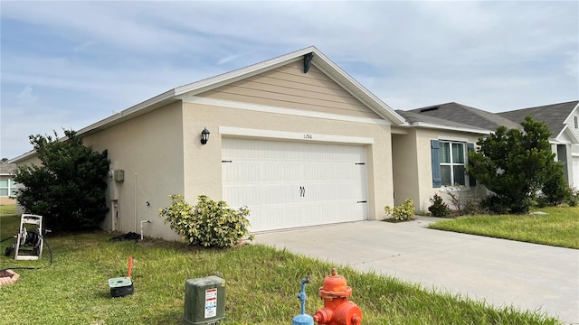 view of front of property featuring a garage and a front lawn