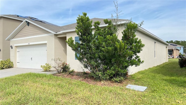 view of side of property with a garage and a lawn