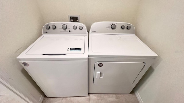 clothes washing area with washer and clothes dryer