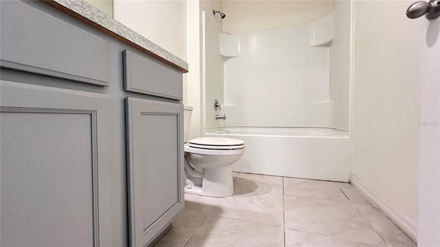 bathroom featuring washtub / shower combination, tile patterned floors, and toilet