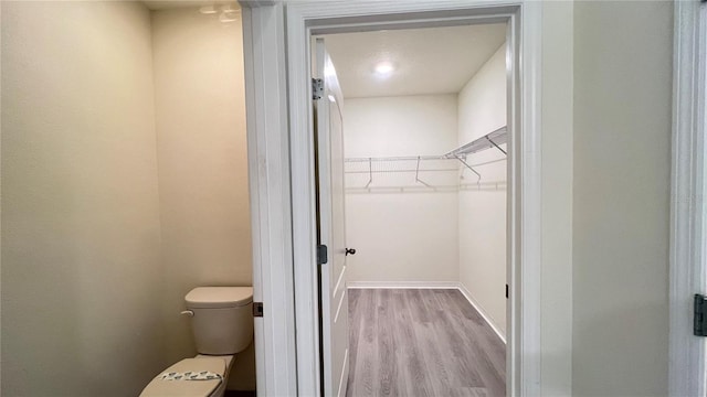 bathroom featuring toilet and hardwood / wood-style floors