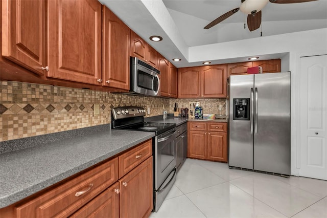 kitchen featuring tasteful backsplash, stainless steel appliances, ceiling fan, light tile patterned floors, and lofted ceiling