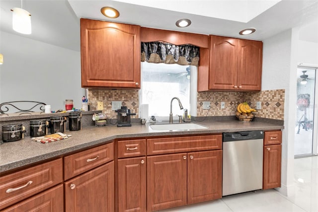 kitchen featuring stainless steel dishwasher, decorative backsplash, light tile patterned floors, and sink