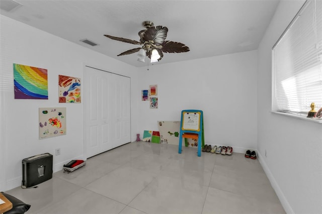 game room featuring ceiling fan and light tile patterned floors