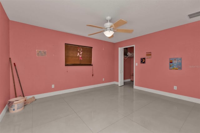 tiled spare room with ceiling fan