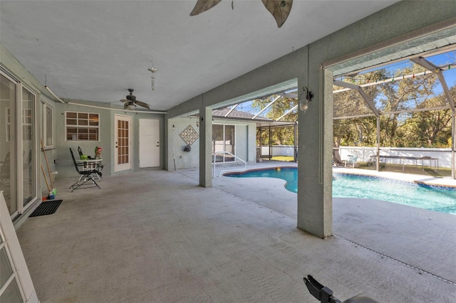 view of pool with a lanai, a patio area, and ceiling fan