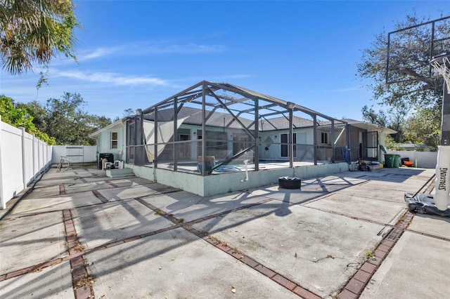 rear view of house featuring a patio, a lanai, and a swimming pool