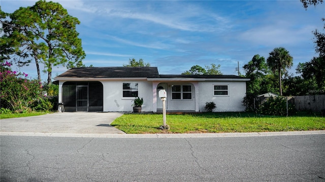 ranch-style home with a carport and a front yard