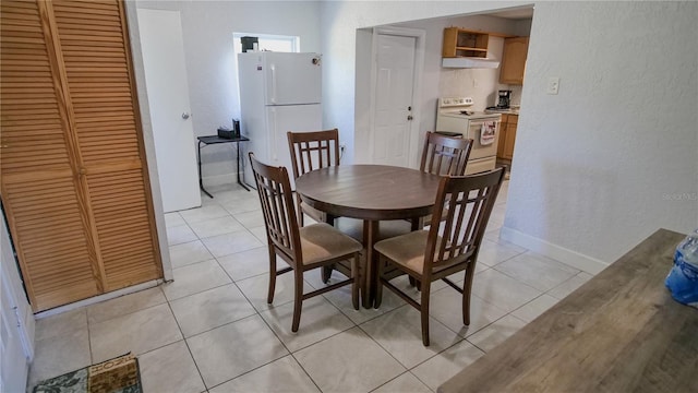 dining area featuring light tile patterned floors