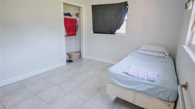 bedroom with light tile patterned floors