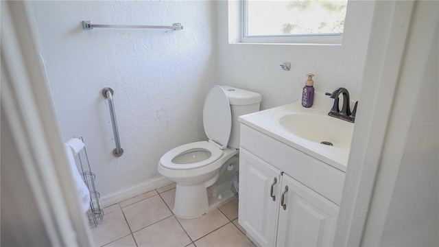 bathroom with vanity, toilet, and tile patterned floors