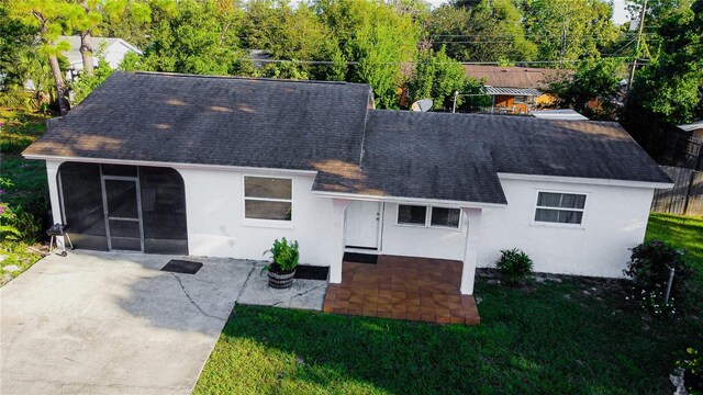 view of front of house with a front yard and a patio area