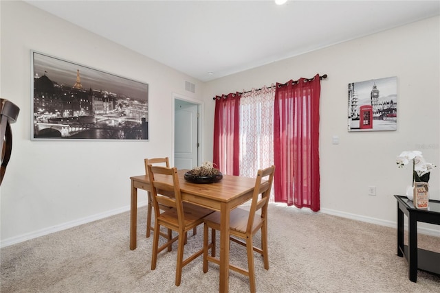 dining space with light carpet