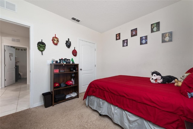 carpeted bedroom with a textured ceiling