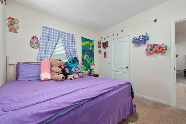 bedroom featuring light carpet, a textured ceiling, and vaulted ceiling