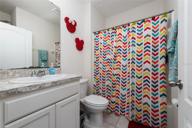 bathroom with tile patterned floors, toilet, walk in shower, and vanity