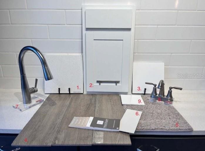 details featuring light stone countertops and white cabinetry