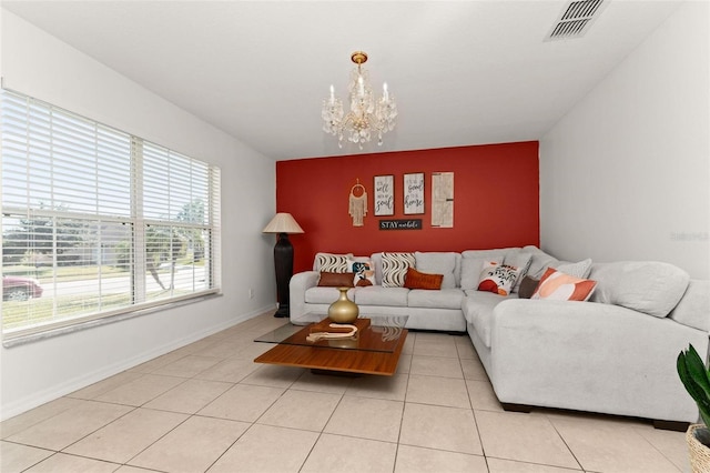 tiled living room with a notable chandelier