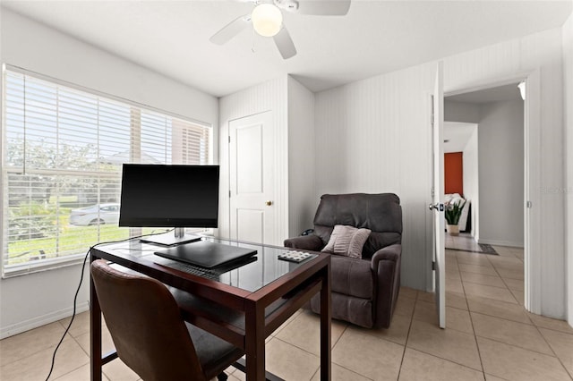 home office featuring ceiling fan, a wealth of natural light, and light tile patterned flooring