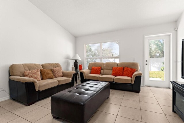 tiled living room with lofted ceiling and a wealth of natural light