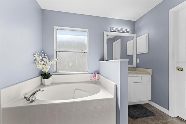 bathroom with tile patterned flooring, tiled bath, and vanity