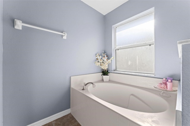 bathroom featuring tiled bath and tile patterned floors