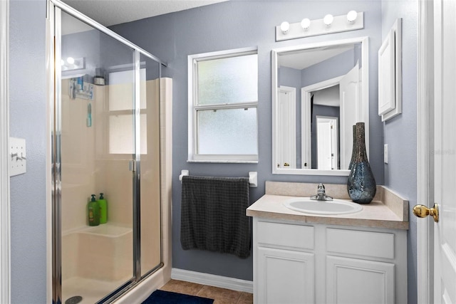 bathroom featuring vanity, a shower with door, and tile patterned floors