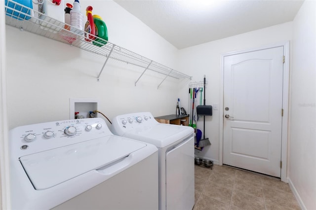 laundry area featuring separate washer and dryer and light tile patterned floors