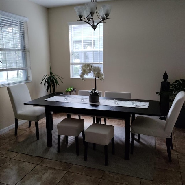 tiled dining space featuring a chandelier