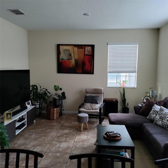 living room with tile patterned flooring