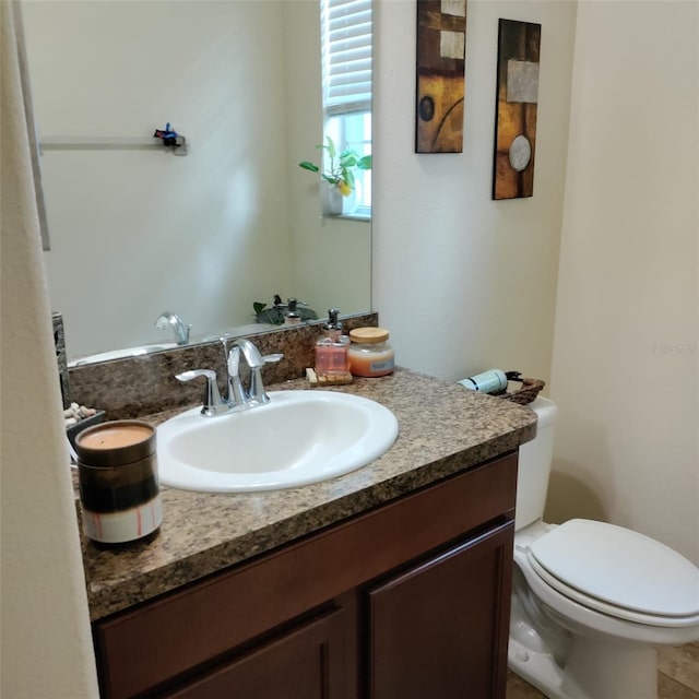 bathroom featuring vanity and toilet