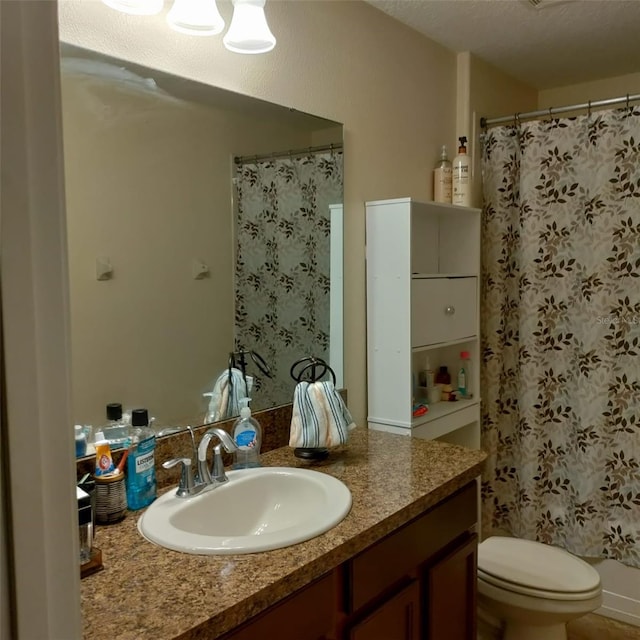 bathroom featuring vanity, toilet, a textured ceiling, and a shower with curtain