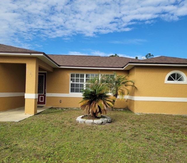 view of side of property with a yard