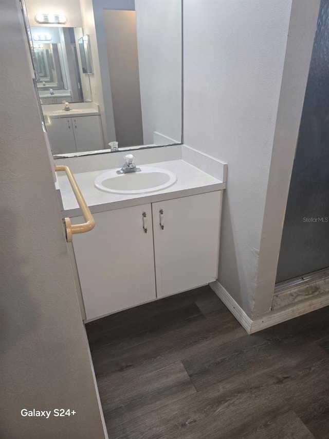 bathroom featuring vanity and hardwood / wood-style floors