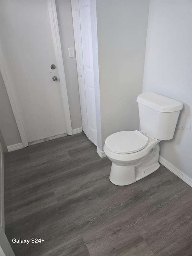 bathroom featuring hardwood / wood-style flooring and toilet