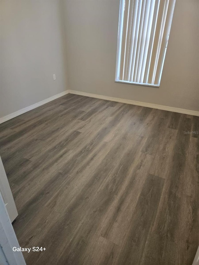 spare room with dark hardwood / wood-style flooring