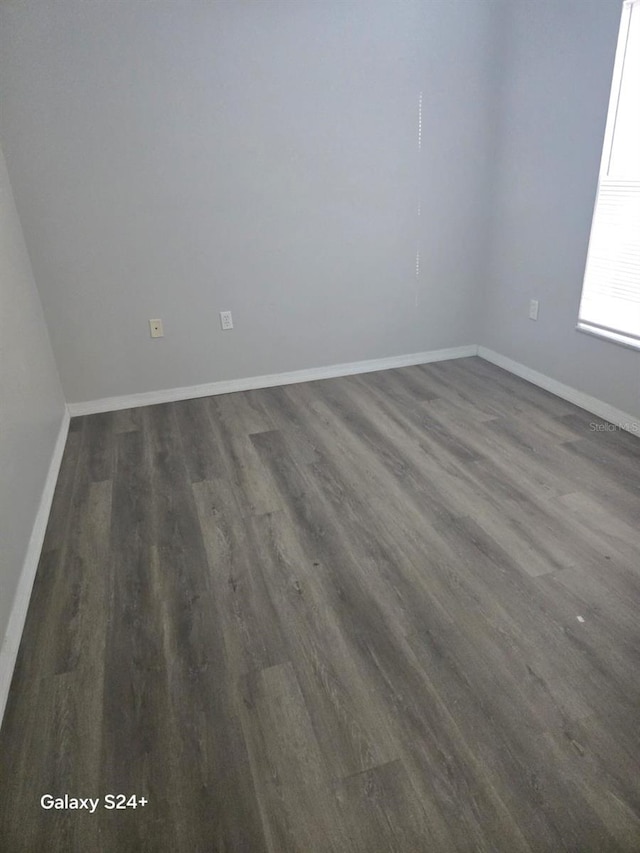 empty room with dark wood-type flooring