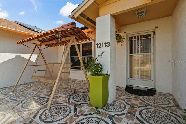 property entrance featuring a patio